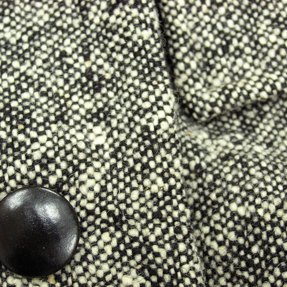Close-up of a black-and-white woven tweed with a stitched seam